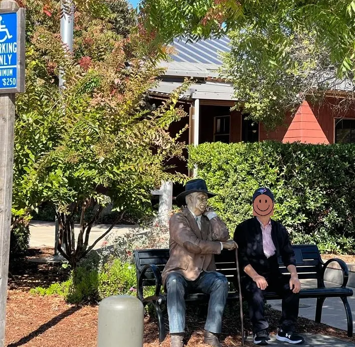 Seward Johnson's famous 'Sidewalk Judge' bronze statue on a Washington Street bench in Yountville during a San Francisco to Napa Valley day trip