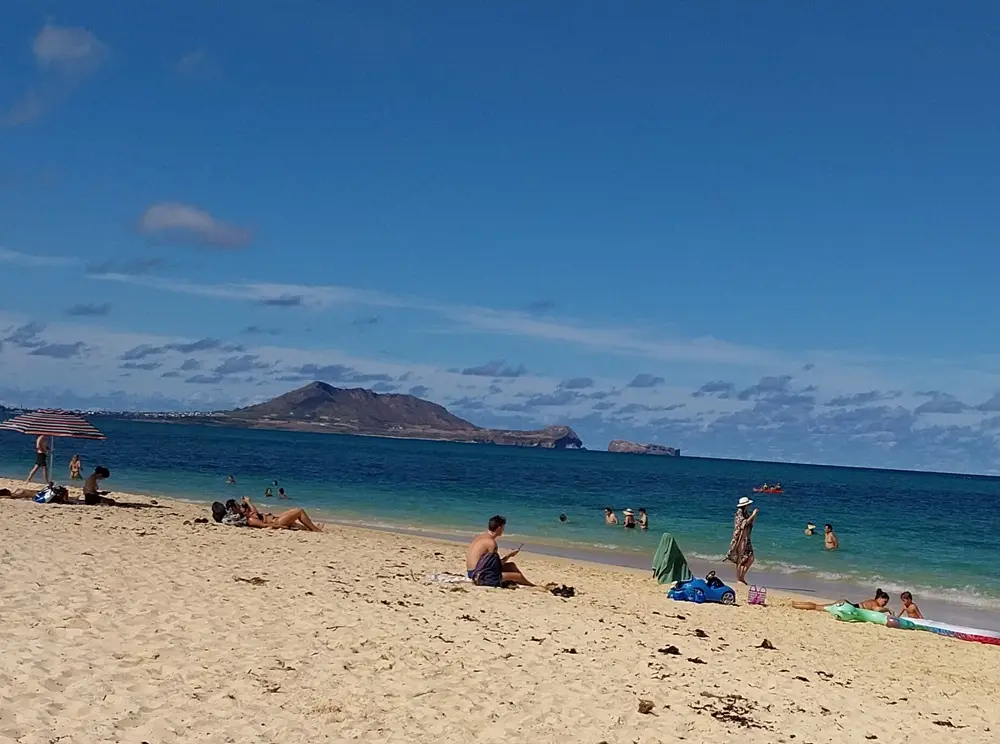Family travelers enjoying a relaxing time together, following useful Lanikai Beach tips for a perfect day out