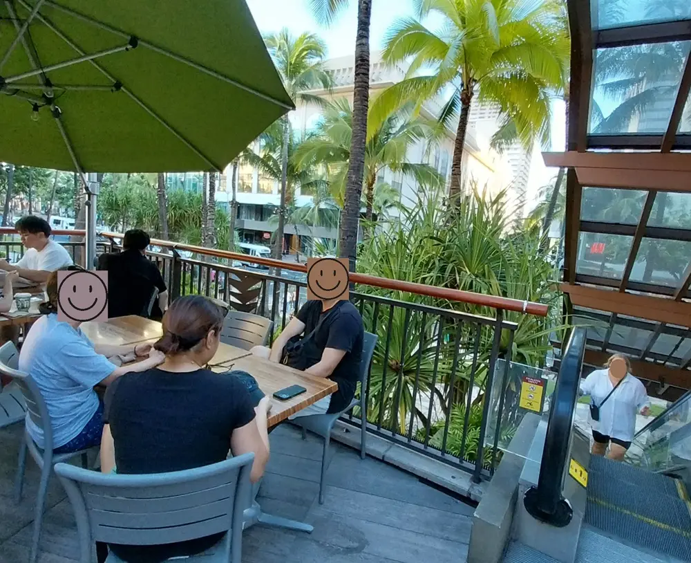 The relaxing open-air outdoor seating area at Island Vintage Coffee, perfect for breakfast before a diamond head hike