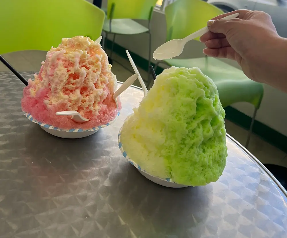 A giant, finely shaved Hawaiian ice topped with colorful sweet syrups at Shimazu Shave Ice, a rewarding dessert after a diamond head hike