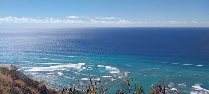 Pacific Ocean color gradient view from Diamond Head summit staircase, from turquoise shoreline to deep navy blue