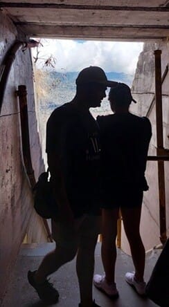 Silhouette shot inside the Diamond Head hiking tunnel with natural light streaming from the exit