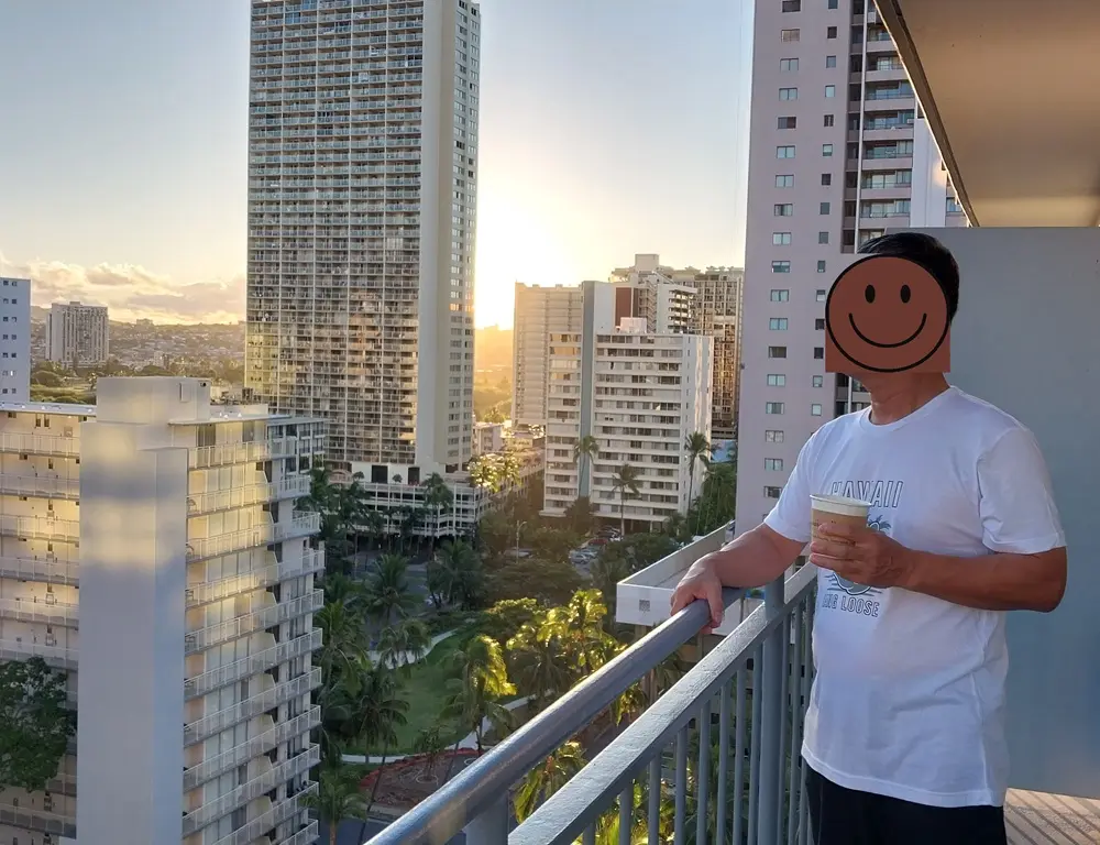 Beautiful morning sunrise viewed from the private hotel room balcony with a cup of coffee during an Oahu Hawaii first day itinerary
