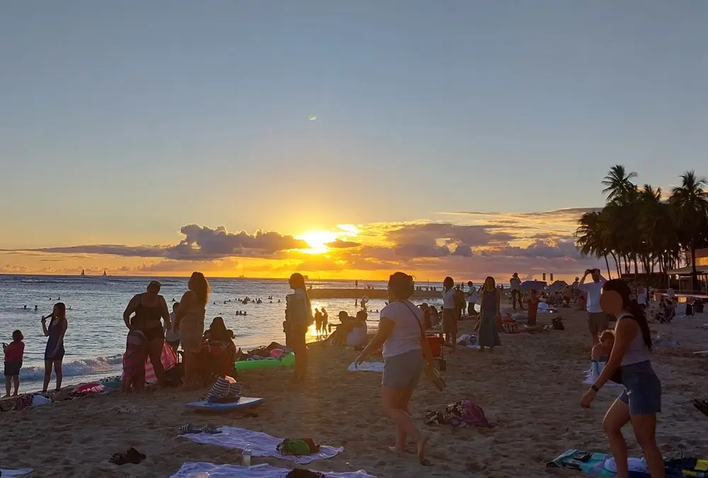 A breathtaking golden sunset glowing over the horizon of Waikiki Beach, wrapping up an Oahu Hawaii first day itinerary