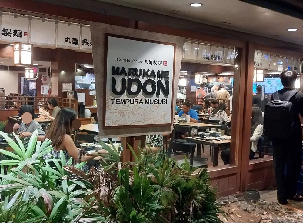 The busy entrance and interior of Marugame Udon in Waikiki, a popular dinner spot for an Oahu Hawaii first day itinerary